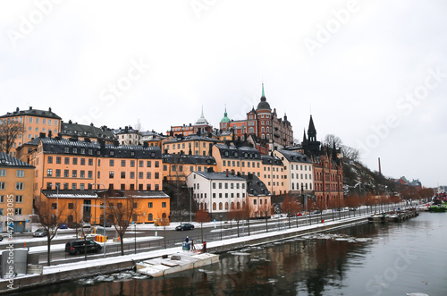 Colourful buildings along the snowy riverside in the centre of Stockholm, Sweden.