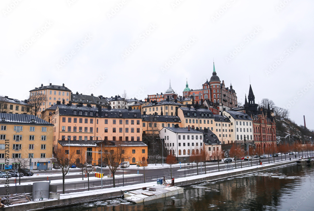Snow Södermalm buildings atop the icy riverside, Stockholm, Sweden.