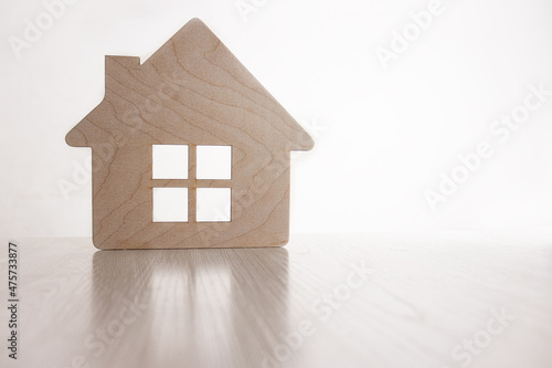a symbol of home and comfort. Wooden figurine of a house. Selective focus © Olga