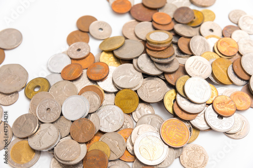 Many kind of coin country pile up on white background.