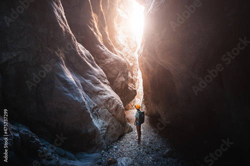Fototapete Happy alone woman wearing helmet for safety is engaged in active canyoning and hiking along the Saklikent Gorge in Turkey