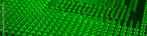 Computer processor close-up. Bright green tinted banner. Information technology headline. A pattern of contacts and semiconductors of a PC microprocessor. Macro