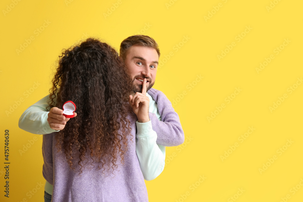 Young man going to make proposal to his girlfriend on color background Young man going to make proposal to his girlfriend on color background