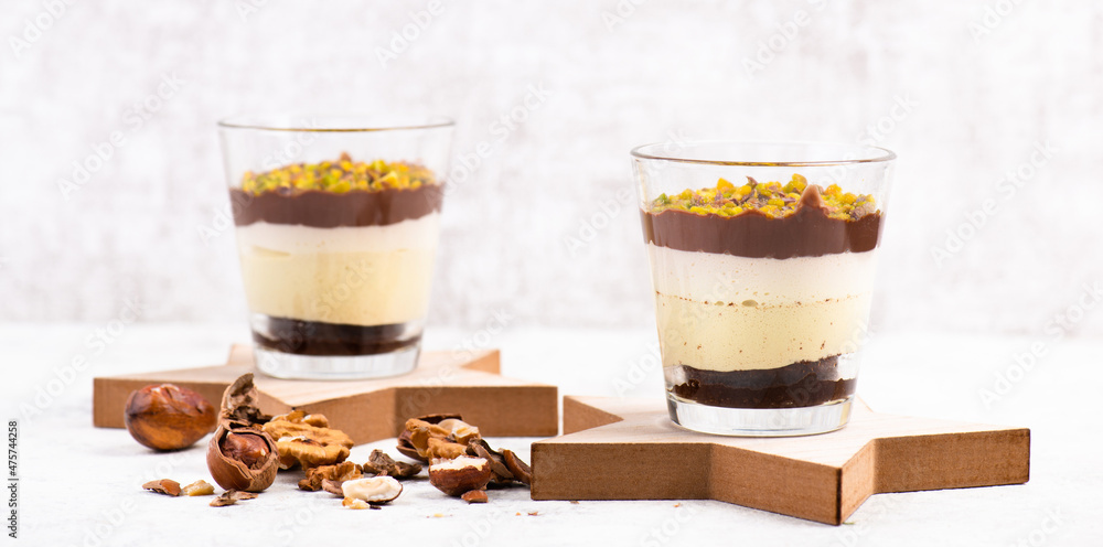 Dessert with chocolate cream, cake and nuts in a glass, sweet food, christmas season Dessert with chocolate cream, cake and nuts in a glass, sweet food, christmas season