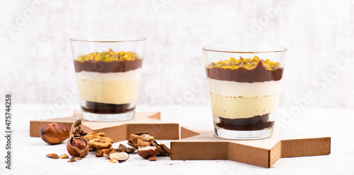 Dessert with chocolate cream, cake and nuts in a glass, sweet food, christmas season