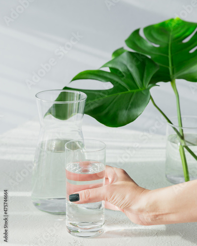 Females hand holds a glass of clean water