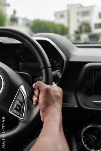 interior of a car with a driver holding the steering wheel, lifestyle and transportation in the city, speed and elegant vehicle © Alejandro