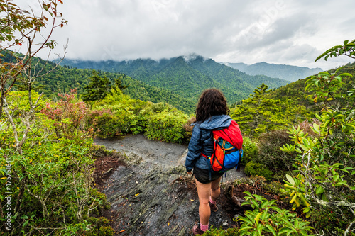 Woman hikes by beautiful cloudy overlook in the Great Smoky Mountains National Park