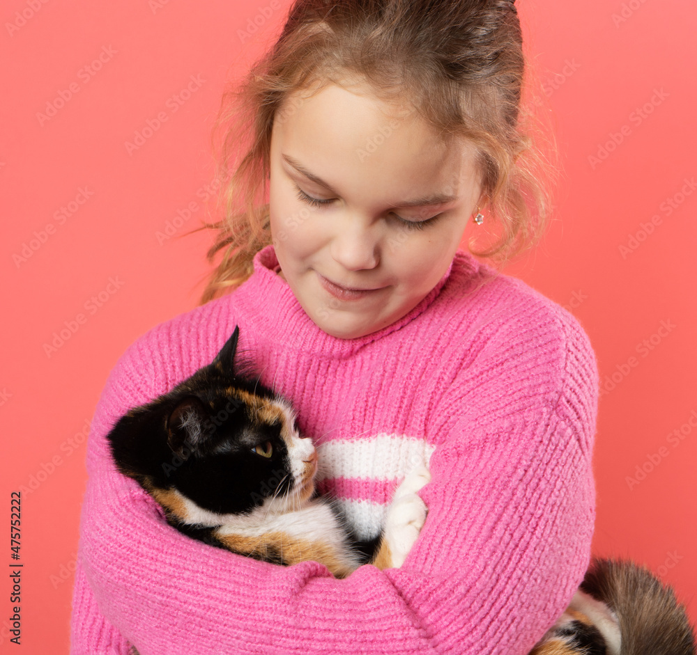 Little Girl Holding her little Cat on pink