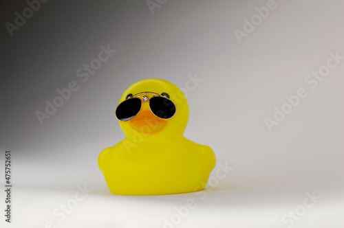 yellow rubber duck on white background in black sunglasses