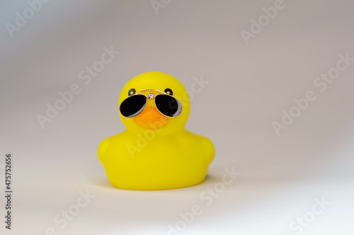 yellow rubber duck on white background in black sunglasses