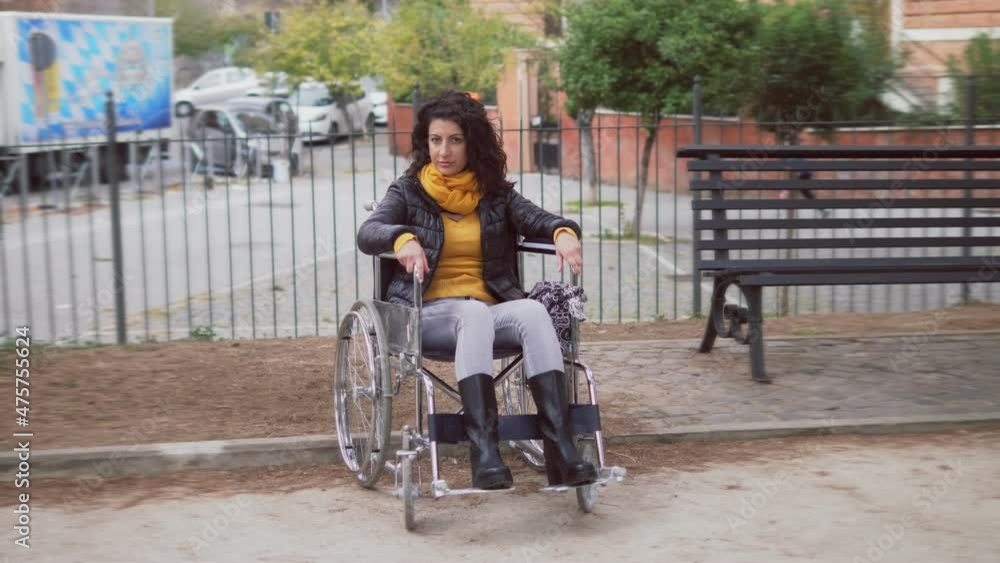 disability, solitude - young woman using wheelchair alone in the park disability, solitude - young woman using wheelchair alone in the park