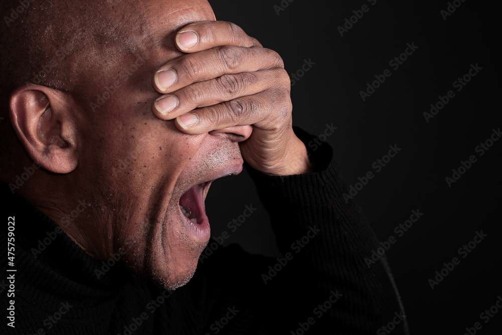 man praying to god with hands together on black background stock photo man praying to god with hands together on black background stock photo
