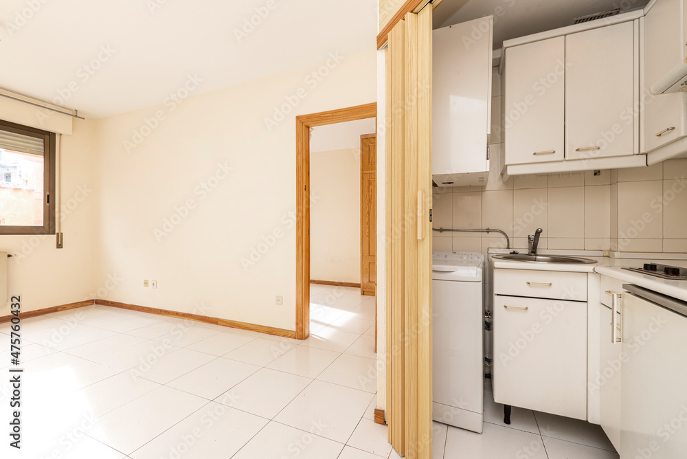 Apartment with small kitchen, bedroom with pine wood wardrobe and white tiles Apartment with small kitchen, bedroom with pine wood wardrobe and white tiles