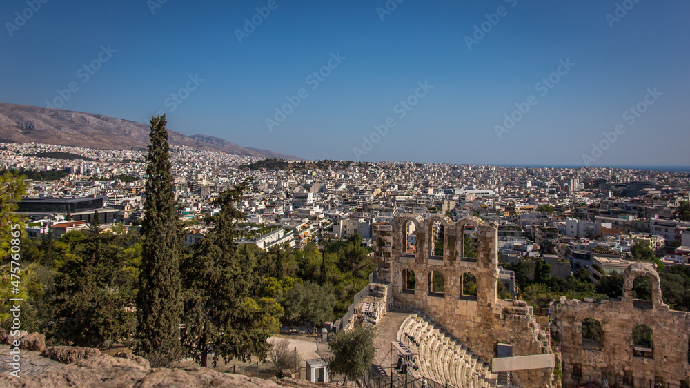 Showing a small part of The Theatre of Herodeon Atticus or Odeon of Herodes Atticus or Herodeon with a panoramic view of Athens in Greece.
