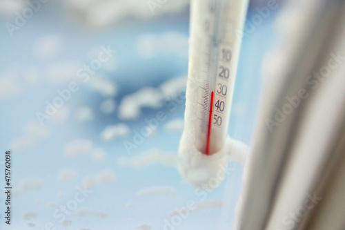 Classic mercury thermometer for measuring ambient temperature, hanging outside the window, with readings minus 30 degrees Celsius.