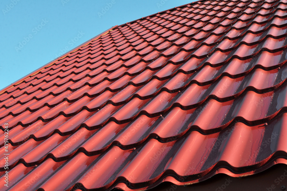 The roof of the house is covered with metal tiles The roof of the house is covered with metal tiles