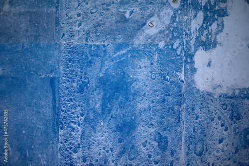 Blue paint on concrete walls covered with plaster.