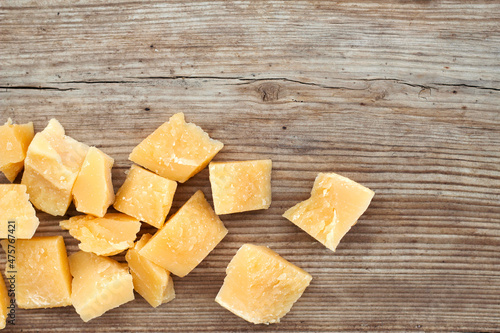 parmesan cheese cubes on wooden board with top view