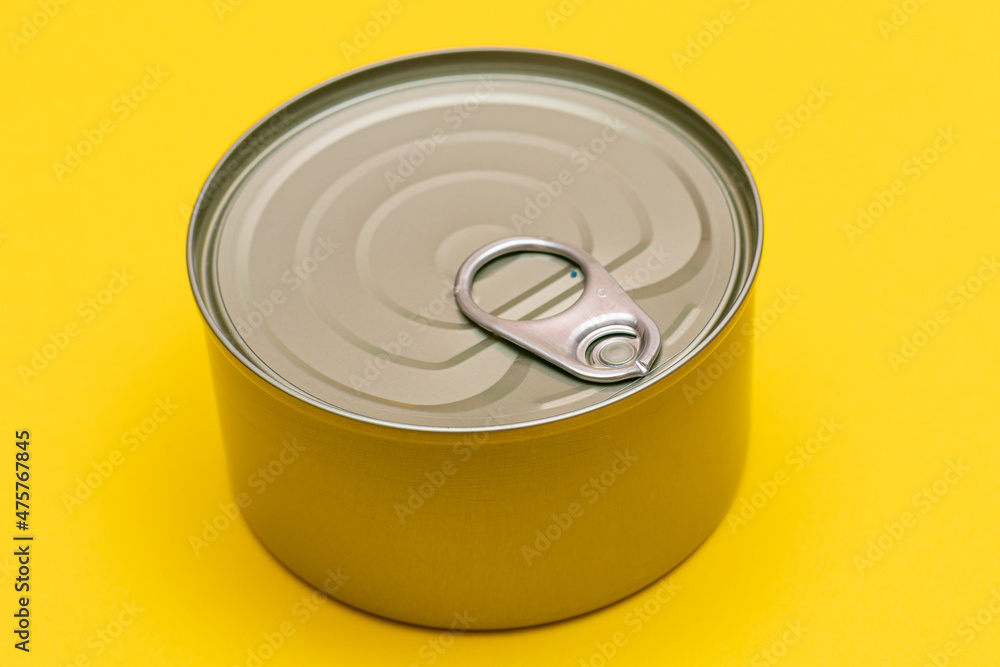 Unopened Tin Can with Blank Edge on Yellow Background. Canned Food. Aluminum Can for Safe and Long Term Storage of Food. Steel Sealed Food Storage Container Unopened Tin Can with Blank Edge on Yellow Background. Canned Food. Aluminum Can for Safe and Long Term Storage of Food. Steel Sealed Food Storage Container