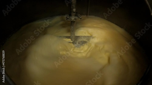 stirrer quickly mixes the flour in the wort kettle while making the whiskey mash 
