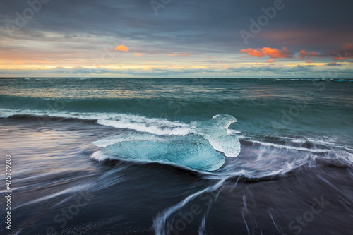 Ice block at the famous diamond beach at sunrise, Iceland. © p_rocha