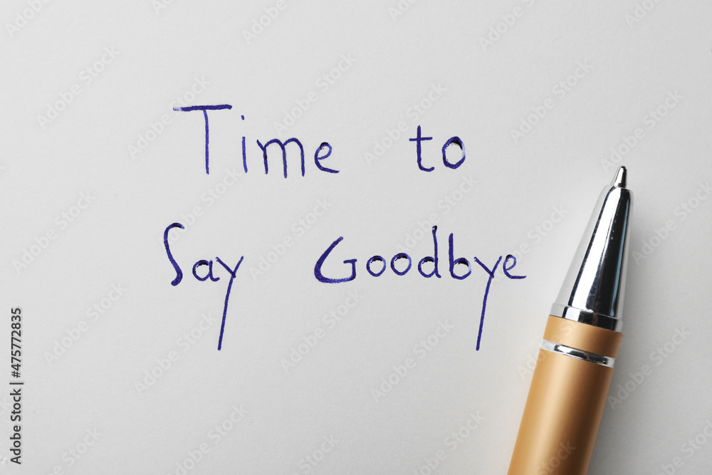 Pen and phrase Time to say Goodbye written on white paper, top view Pen and phrase Time to say Goodbye written on white paper, top view