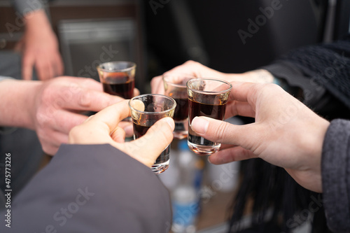 Four friends toast to health and drink liquor