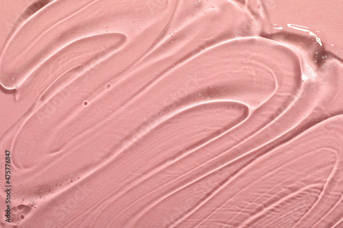 Transparent cosmetic gel on pink background, closeup view