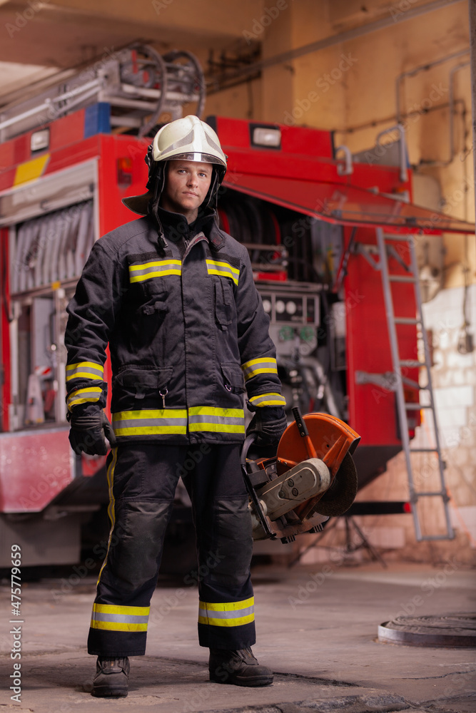 Professional firefighter in uniform wearing protective helmet and