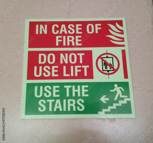 Information of safety worning banner, in case of fire do not use lift use the stairs photo
