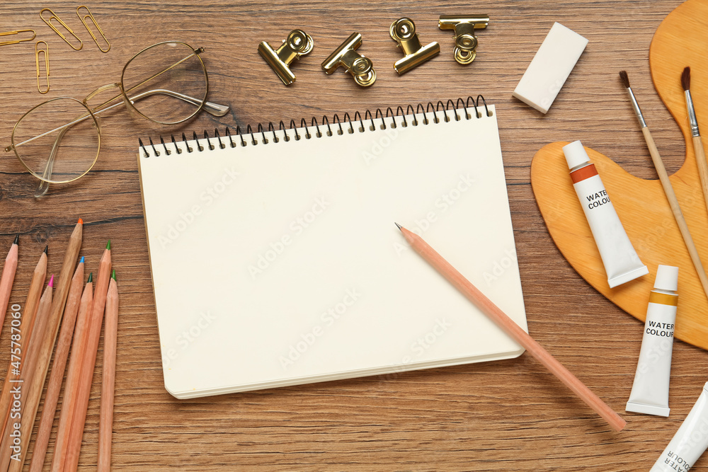 Flat lay composition with blank sketchbook on wooden table. Space for text Flat lay composition with blank sketchbook on wooden table. Space for text