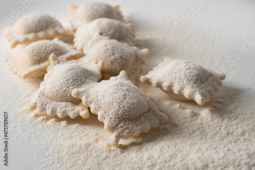 Ravioli pasta squares sprinkled with flour. Selective focus