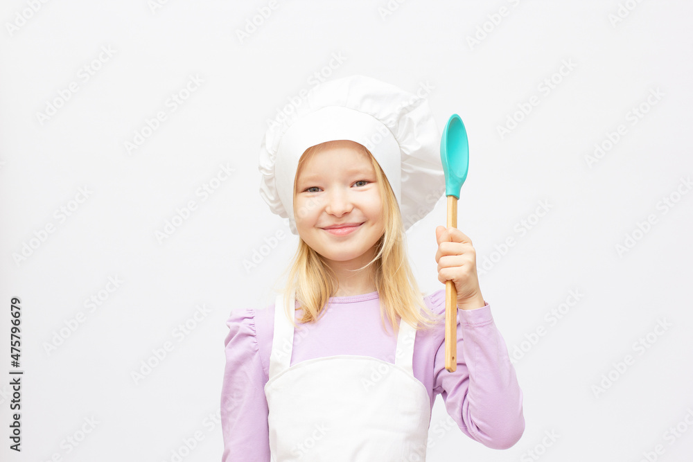 Happy little girl chef holding the ladle spoon Happy little girl chef holding the ladle spoon