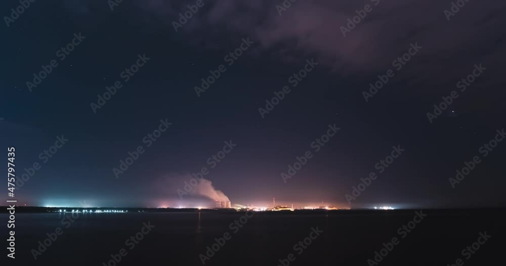 Smoke from the chimneys of a thermal power plant on a night timelapse ...