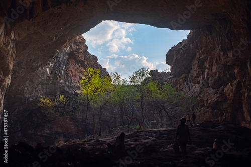Akmeshit or Akmechet cave. Huge cavern with hole and green trees groving under.