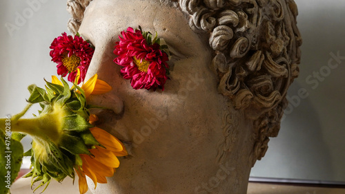 Statue of Alexander the great ornamented with colorful flowers