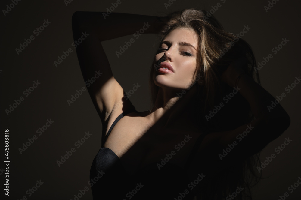 Fashion model, black vogue of elegant girl. High fashion look. Glamor woman portrait, dark beautiful face, female isolated on black background, stylish sexy look, young lady in studio.