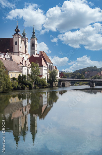View of Österreichisches Weihnachtsmuseum and its reflection in the Steyr river from Museumssteg bridge.