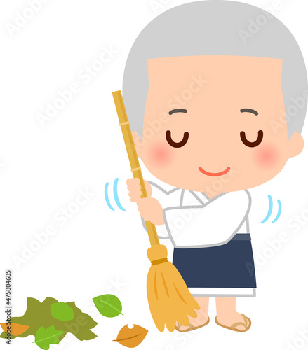 竹箒で落ち葉を掃くお寺の小僧さん