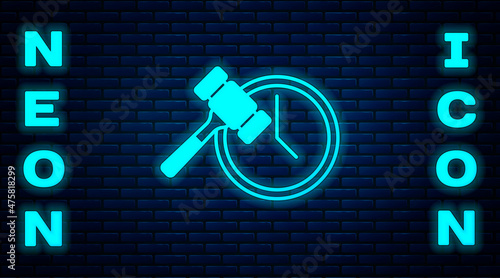 Glowing neon Auction hammer icon isolated on brick wall background. Gavel - hammer of judge or auctioneer. Bidding process, deal done. Auction bidding. Vector