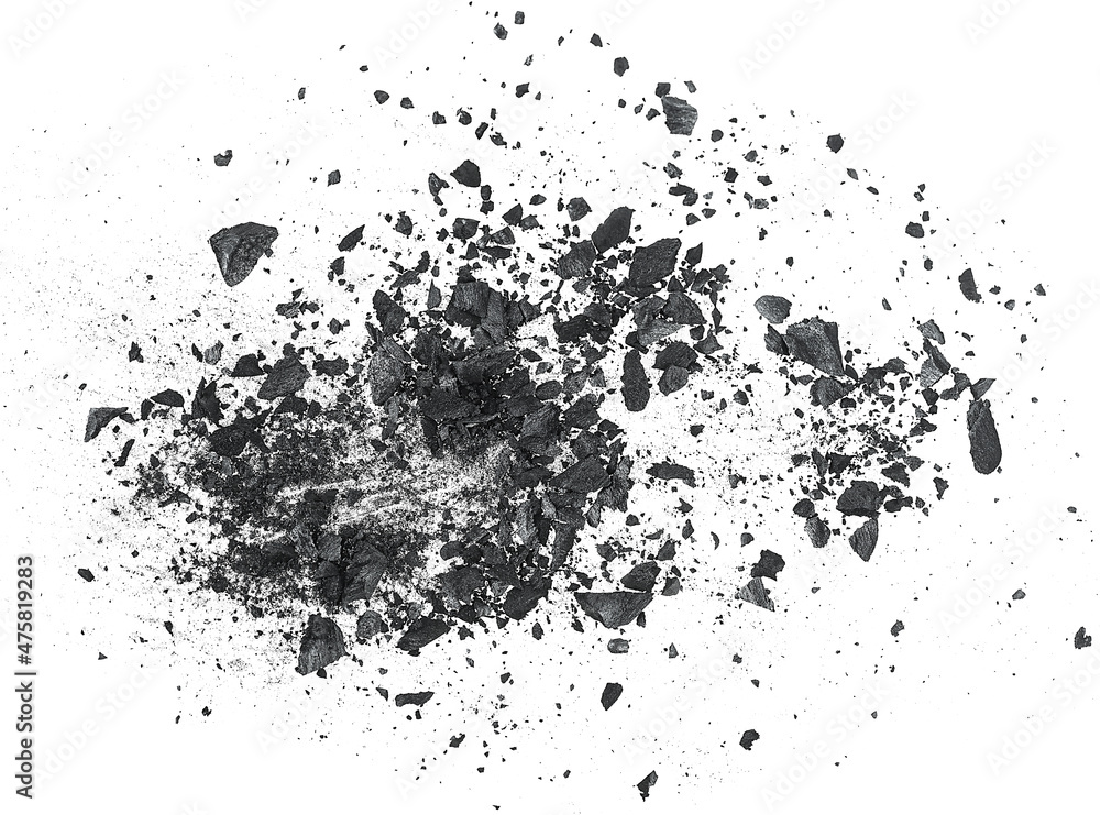Black dust powder of charcoal with fragments on a white background, top view.