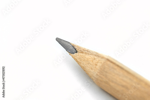 Macro photo of a sharpened pencil, isolated on a white background.