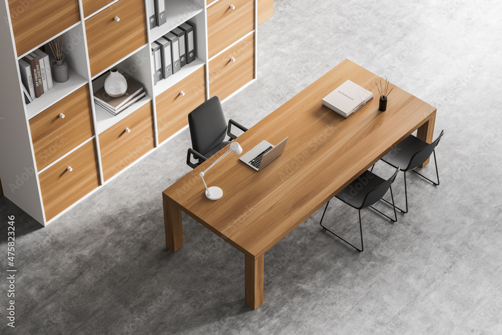 Top view of business room interior with desk and seats, bookshelf on grey floor Top view of business room interior with desk and seats, bookshelf on grey floor