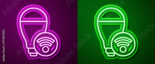 Glowing neon line Smart light bulb system icon isolated on purple and green background. Energy and idea symbol. Internet of things concept with wireless connection. Vector
