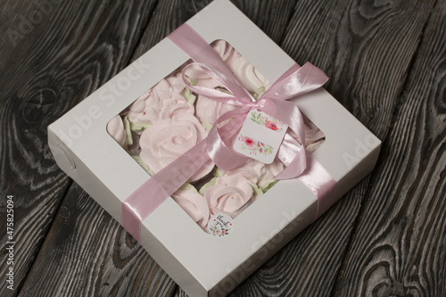 Homemade marshmallow in a gift box. Zephyr in the form of roses. Close-up shot.
