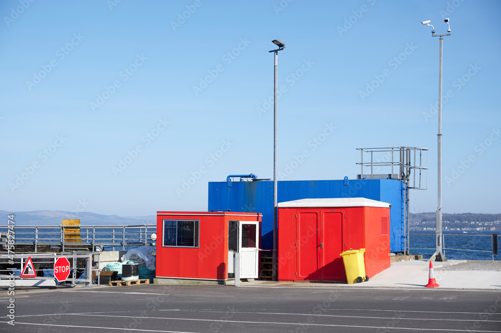 Red and blue storage containers at ferry port in Oban Scotland Red and blue storage containers at ferry port in Oban Scotland