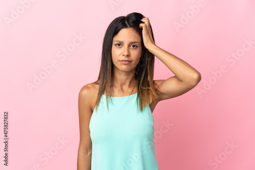 Caucasian girl isolated on pink background with an expression of frustration and not understanding