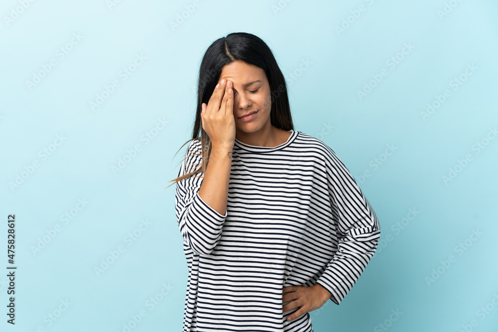 Caucasian girl isolated on blue background with headache Caucasian girl isolated on blue background with headache