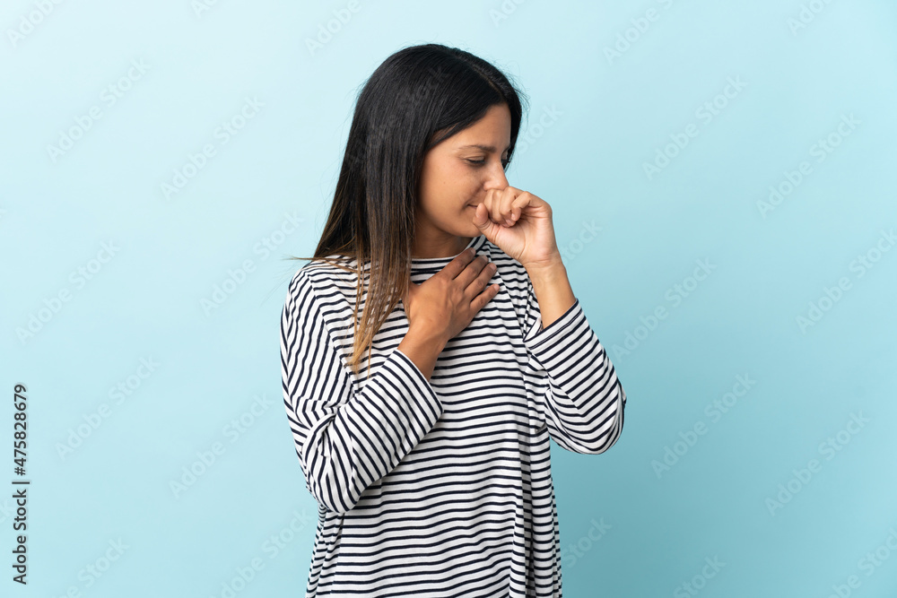 Caucasian girl isolated on blue background coughing a lot Caucasian girl isolated on blue background coughing a lot